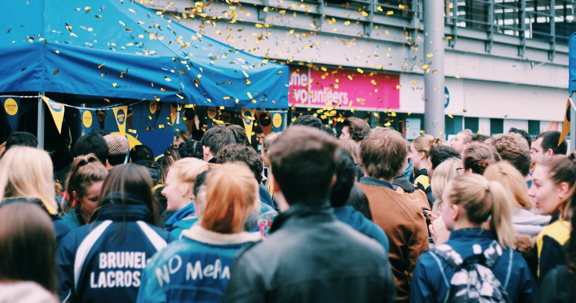 A crowd gathers around a tent for a loyalty programme promotional event in London.