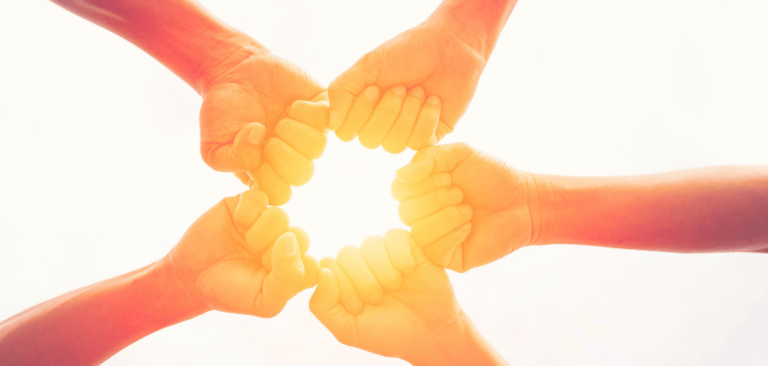 hands in a circle showing connection of group